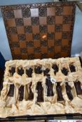 A RESIN CHESS SET, the pieces modelled as figures from the Elizabethan Court, complete with board,