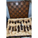 A RESIN CHESS SET, the pieces modelled as figures from the Elizabethan Court, complete with board,