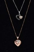 TWO DIAMOND PENDANT NECKLACES, the first a white metal double heart pendant set with colourless