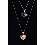 TWO DIAMOND PENDANT NECKLACES, the first a white metal double heart pendant set with colourless