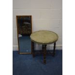 A CIRCULAR BRASS TABLE TOP on a folding beech frame, along with an oak rectangular wall mirror (2)