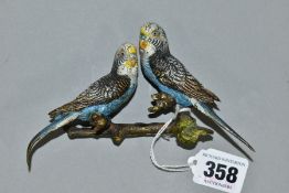 A PAIR OF COLD PAINTED BRONZED BUDGIES PERCHED ON A BRANCH, the underside has areas of glue