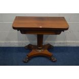 A VICTORIAN ROSEWOOD CARD TABLE, the fold over top enclosing a circular purple baize lining, on a