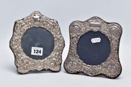 TWO ORNATE SILVER FRAMES, each with a decorative cherub and foliate embossed design, vacant