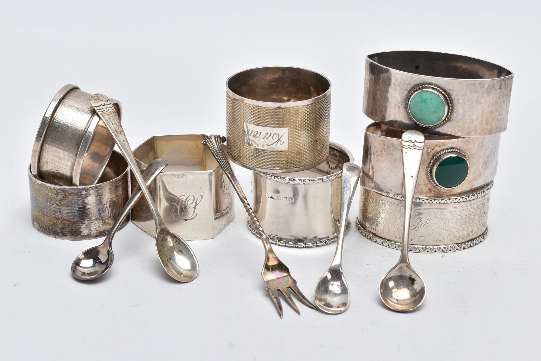 AN ASSORTEMENT OF SILVER NAPKIN RINGS AND SALT SPOONS, to include eight napkin rings of various