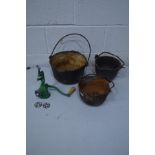THREE VARIOUS IRON CAULDRONS with hooped handles, along with an enamel meat mincer (4)