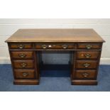 A TITCHMARSH AND GOODWIN OAK PEDESTAL DESK, with nine various drawers, width 138cm x depth 69cm x