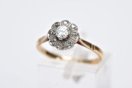 A YELLOW METAL DIAMOND CLUSTER RING, designed as a raised flower cluster set with a central round