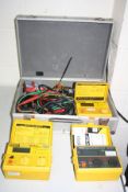 AN ALUMINIUM CASE CONTAINING THREE ROBINS ELECTRICAL TEST METERS including a KMP-3050DL insulation-