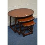 AN OLD CHARM OAK OVAL NEST OF THREE TABLES, largest table width 82cm x depth 55cm x height 54cm