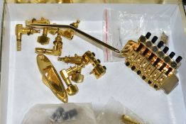 A GOLD PLATED FLOYD ROSE LICENSED TREMOLO, with locking nut and post, a set of gold plated