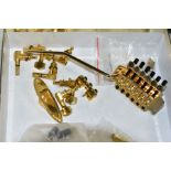 A GOLD PLATED FLOYD ROSE LICENSED TREMOLO, with locking nut and post, a set of gold plated