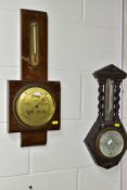 THREE EARLY 20TH CENTURY ANEROID BAROMETERS, one in a worn metal case, the other two in a walnut