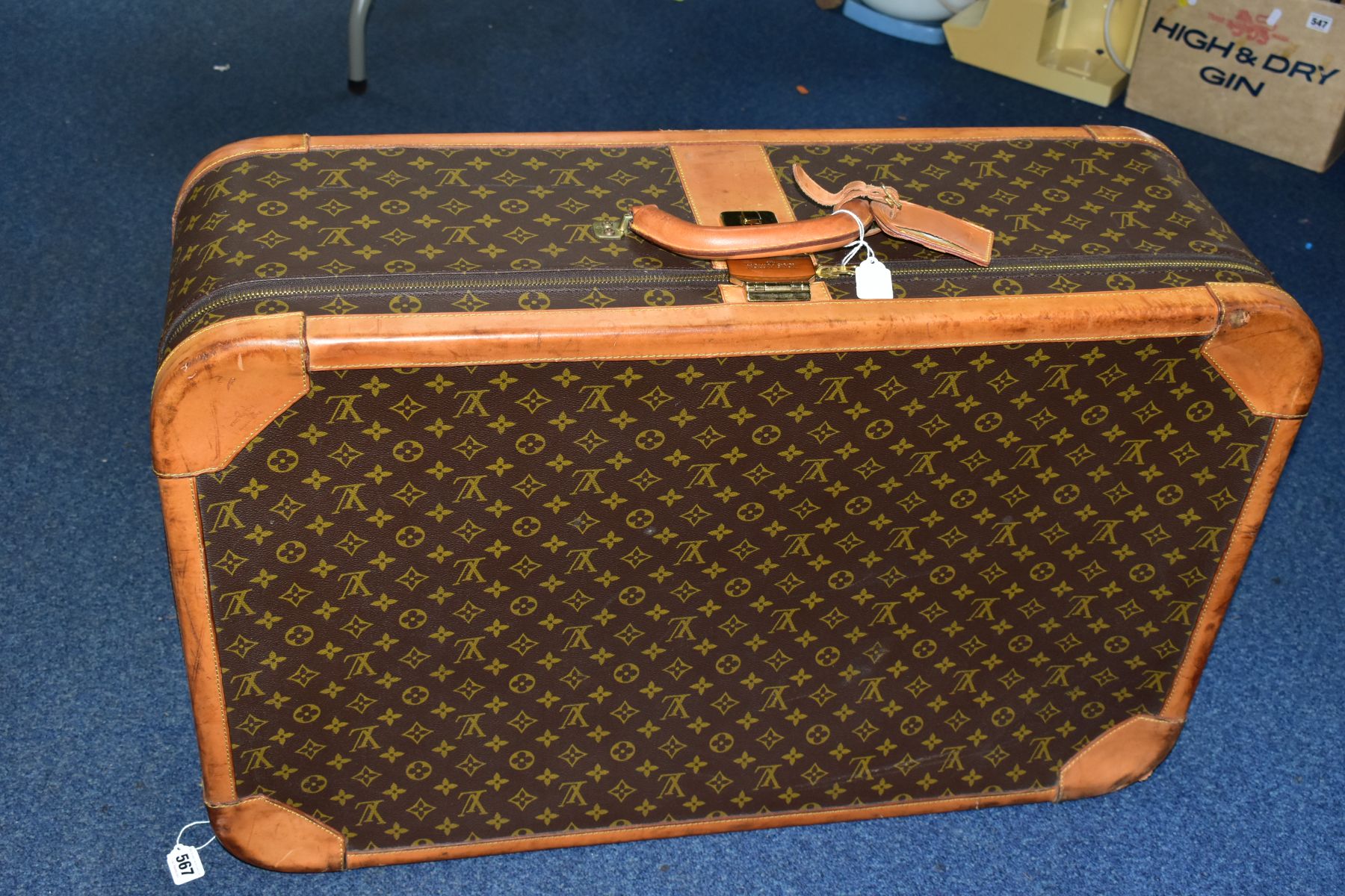 A LOUIS VUITTON MONOGRAM SUITCASE, tan leather trim, with a combination lock (locked, combination