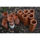 A QUANTITY OF TERRECOTA to include over forty small plant pots and six hexagonal pipes (40+)