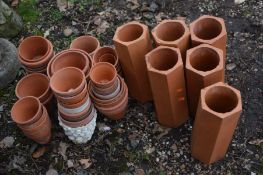 A QUANTITY OF TERRECOTA to include over forty small plant pots and six hexagonal pipes (40+)