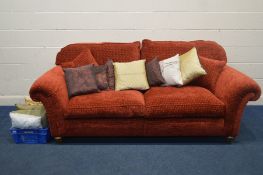 A LARGE RED UPHOLSTERED TWO SEATER SETTEE, width 236cm along with a quantity of cushions