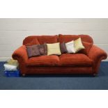 A LARGE RED UPHOLSTERED TWO SEATER SETTEE, width 236cm along with a quantity of cushions