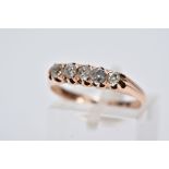 A YELLOW METAL FIVE STONE DIAMOND RING, designed with a row of five, claw set old cut diamonds,
