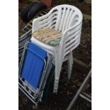A SET OF SIX WHITE PLASTIC GARDEN STACKING CHAIRS together with two metal framed folding deck chairs