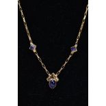A YELLOW METAL BLUE STONE PENDANT NECKLET, the pendant of a Chervon shaped set with an oval cabochon
