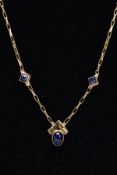 A YELLOW METAL BLUE STONE PENDANT NECKLET, the pendant of a Chervon shaped set with an oval cabochon