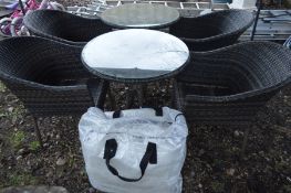 A LEISUREGROW PAIR OF CIRCULAR RATTAN GARDEN TABLES with glass tops, diameter 68cm x height 76cm