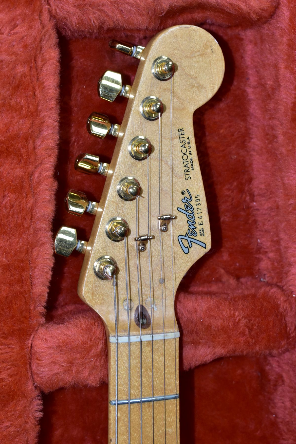 A 1984 USA FENDER STRATOCASTER GUITAR, in red with a one piece maple neck and fingerboard, gold - Image 2 of 6