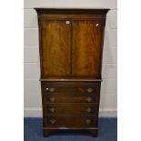 A MAHOGANY TWO DOOR CABINET, with a brushing slide, width 74cm x depth 45cm x height 154cm (