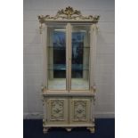 A SILIK BAROQUE STYLE ITALIAN TWO DOOR DISPLAY CABINET, with heavily carved ornate decoration,