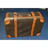 A LOUIS VUITTON MONOGRAM SUITCASE WITH STRAPS, tan leather trim, zips stiff but in working order,