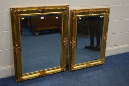 A LATE 20TH CENTURY FOLIATE GILTWOOD FRAMED BEVELLED EDGE WALL MIRROR, 90cm x 68cm and a matching
