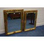 A LATE 20TH CENTURY FOLIATE GILTWOOD FRAMED BEVELLED EDGE WALL MIRROR, 90cm x 68cm and a matching