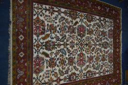 A LARGE WOOLLEN KERMAN RUG, WITH RED, GOLD AND CREAM GROUND, 403cm x 219cm (some low pile)