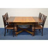 AN EARLY TO MID 20TH CENTURY OAK SQUARE TOPPED DRAW LEAF TABLE, on acorn supports united by a