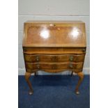 AN EARLY 20TH CENTURY WALNUT BUREAU, with two drawers, on cabriole legs, width 77cm x depth 45cm x