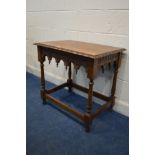 AN OAK TABLE, with a carved top and shaped apron, width 78cm x depth 54cm x height 73cm