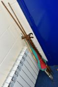 A BUNDLE OF WALKING STICKS, FISHING UMBRELLA, damaged pool cue, two sections from a three section