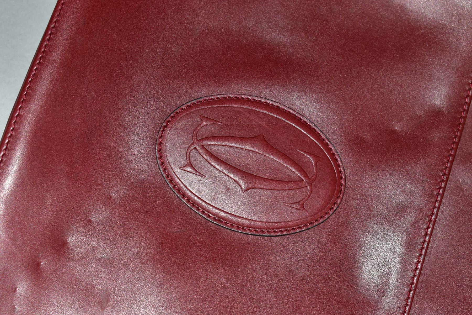 A CARTIER RED LEATHER SOFT BRIEFCASE, case has indentations to the exterior, width 41cm x height - Image 2 of 5