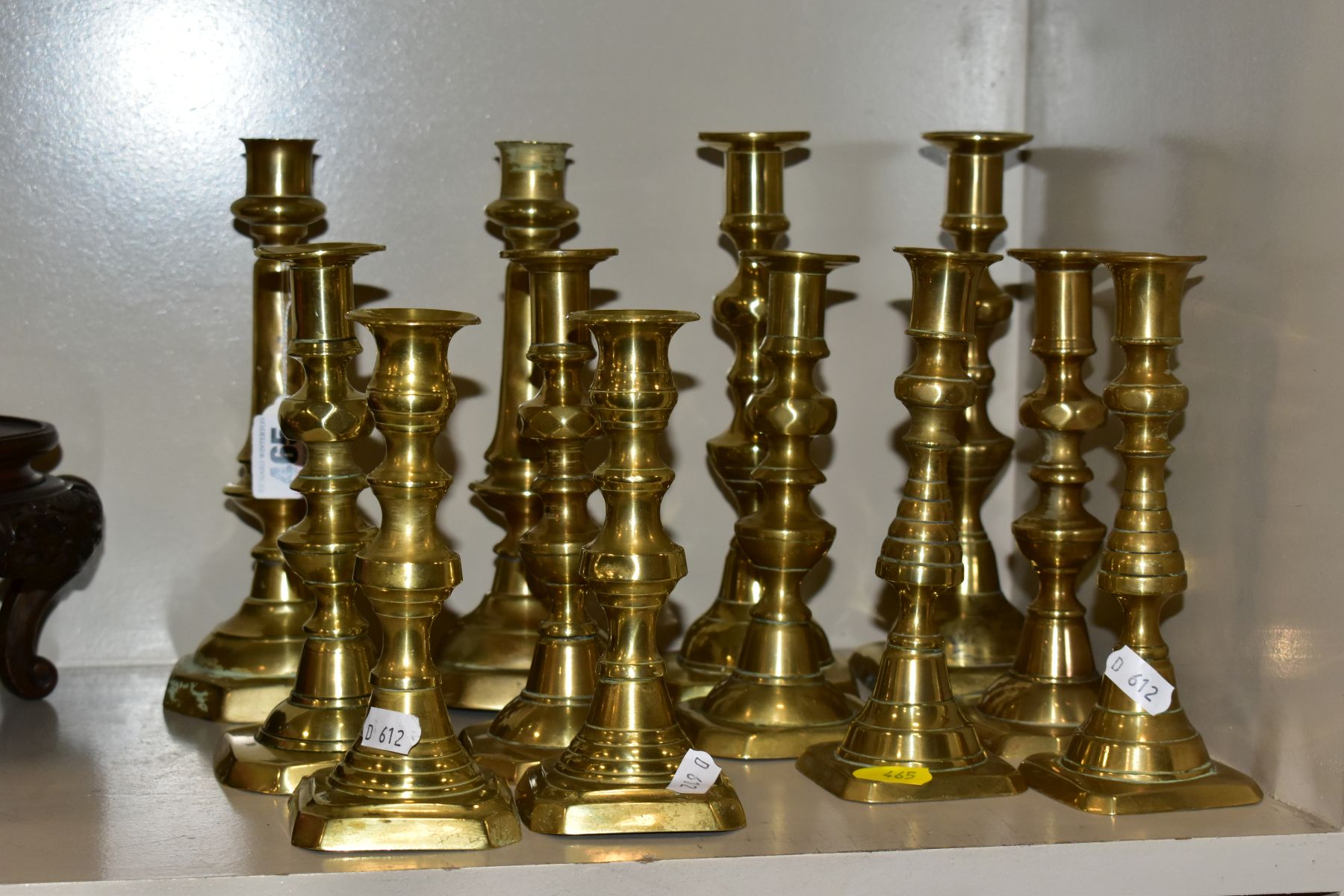 SIX PAIRS OF BRASS CANDLESTICKS, tallest height 22cm and smallest height 16cm, all fitted with