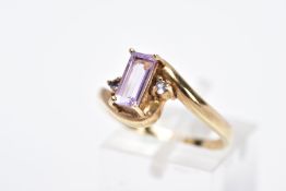 A 9CT GOLD AMETHYST RING, designed with a claw set rectangular cut amethyst flanked with circular