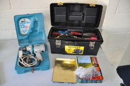 A PLASTIC TOOLBOX and tin containing a small quantity of tools together with a cased Wolf electric