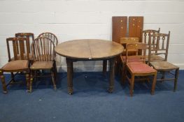 A LATE 19TH CENTURY CIRCULAR OAK WIND OUT DINING TABLE, with two additional leaves, extended