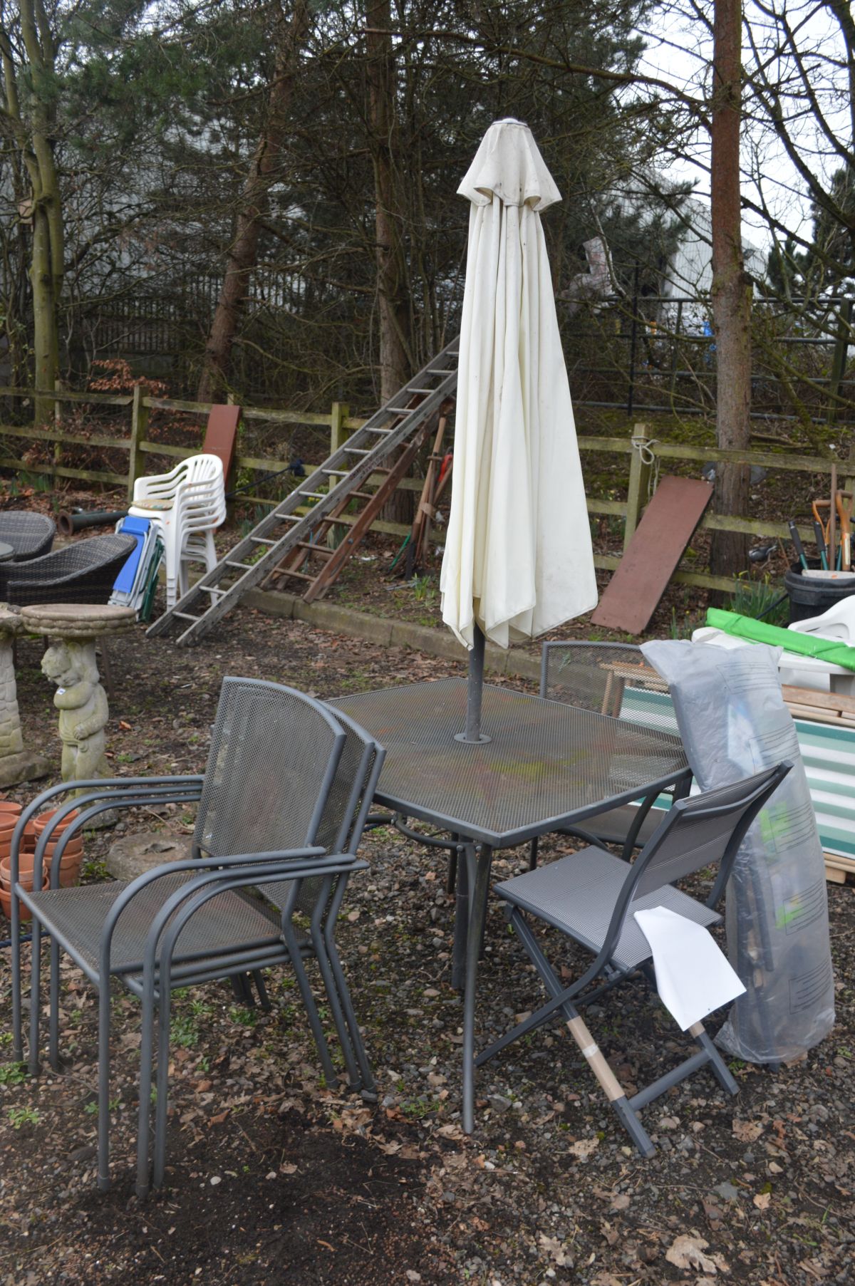 A SQUARE GREY PAINTED METAL GARDEN TABLE with shaped support and legs, parasol (no stand), four