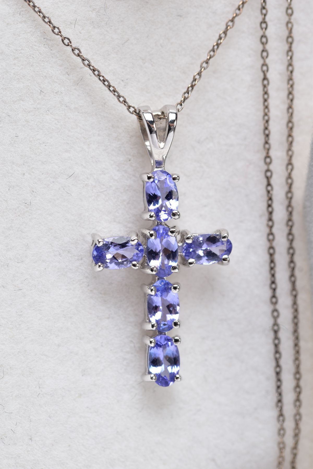 A WHITE METAL CROSS PENDANT NECKLACE AND A TIE PIN, the cross pendant set with six oval cut pale - Image 2 of 2