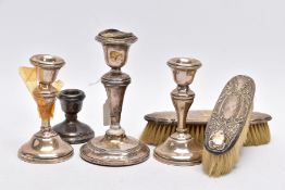 FOUR SILVER CANDLE STICKS AND TWO SILVER LINED CLOTHES BRUSHES, to include a pair of dwarf candle