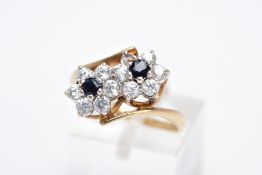 A 9CT GOLD SAPPHIRE AND CUBIC ZIRCONIA DOUBLE CLUSTER RING, designed with two asymmetrical clusters,