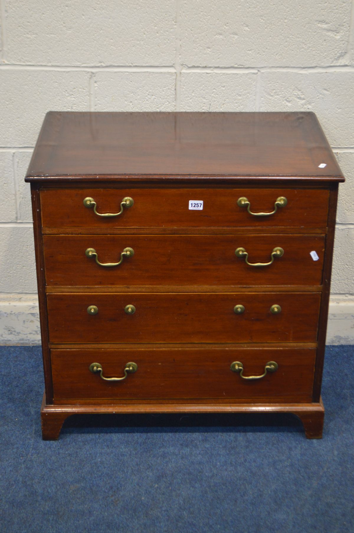 A 20TH CENTURY MAHOGANY CHEST OF FOUR LONG GRADUATED DRAWERS, in the George III style, brass swan