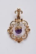 A 9CT GOLD AMETHYST DROP PENDANT, of an openwork floral and scroll detailed design, suspending an