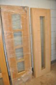 A COLLECTION OF INTERIOR DOORS to include two oak with a single long glaze width 61cm, two oak